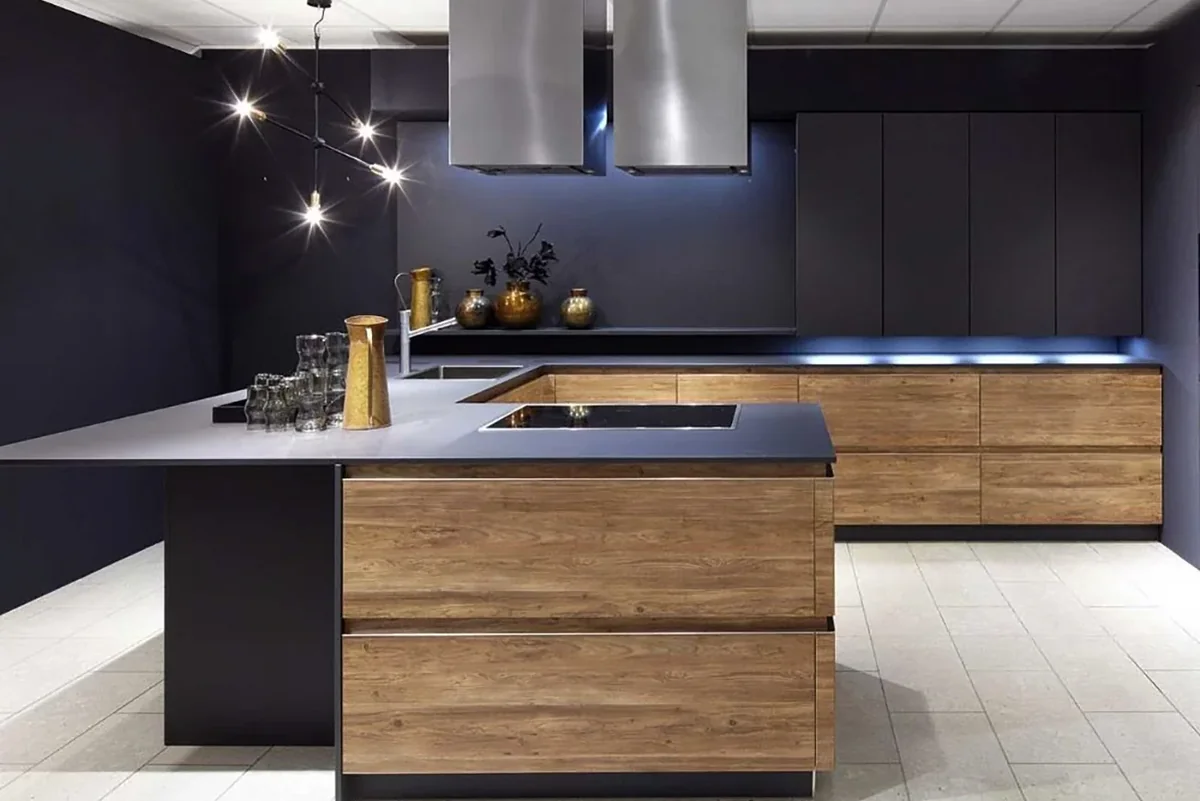 Two-tone anthracite and walnut kitchen with a corner breakfast bar and custom stainless steel hood