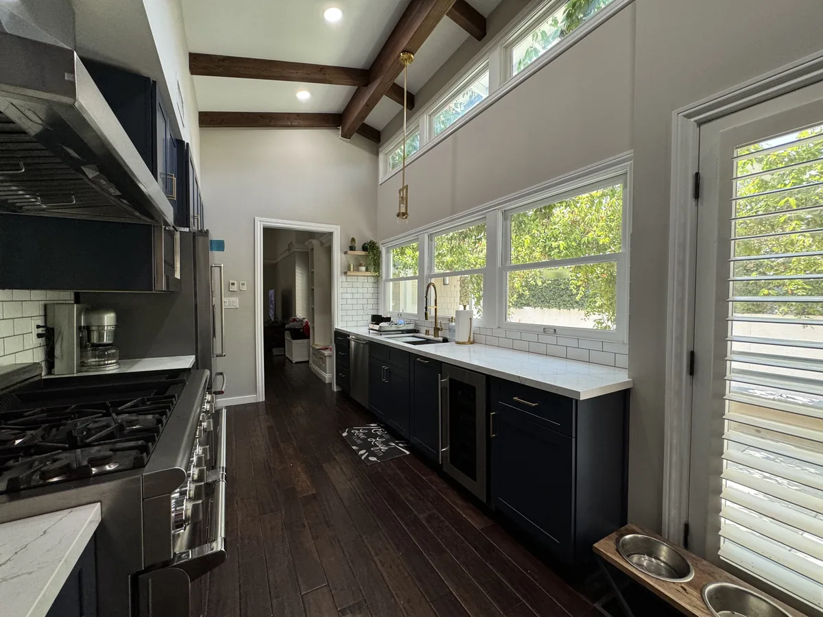 Galley layout with the cooking area opposite the window-lined sink counter