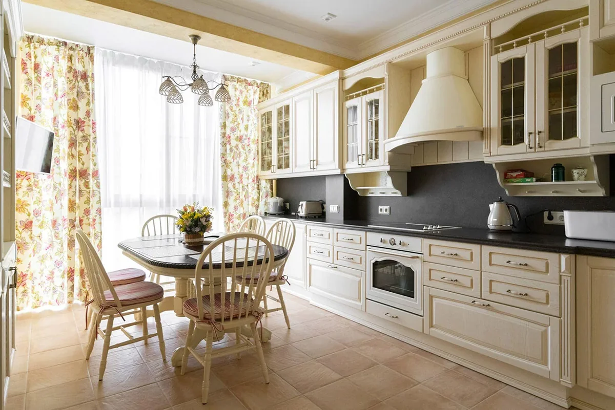 Traditional cream kitchen with raised-panel cabinets, a contrasting dark backsplash, and a custom hood