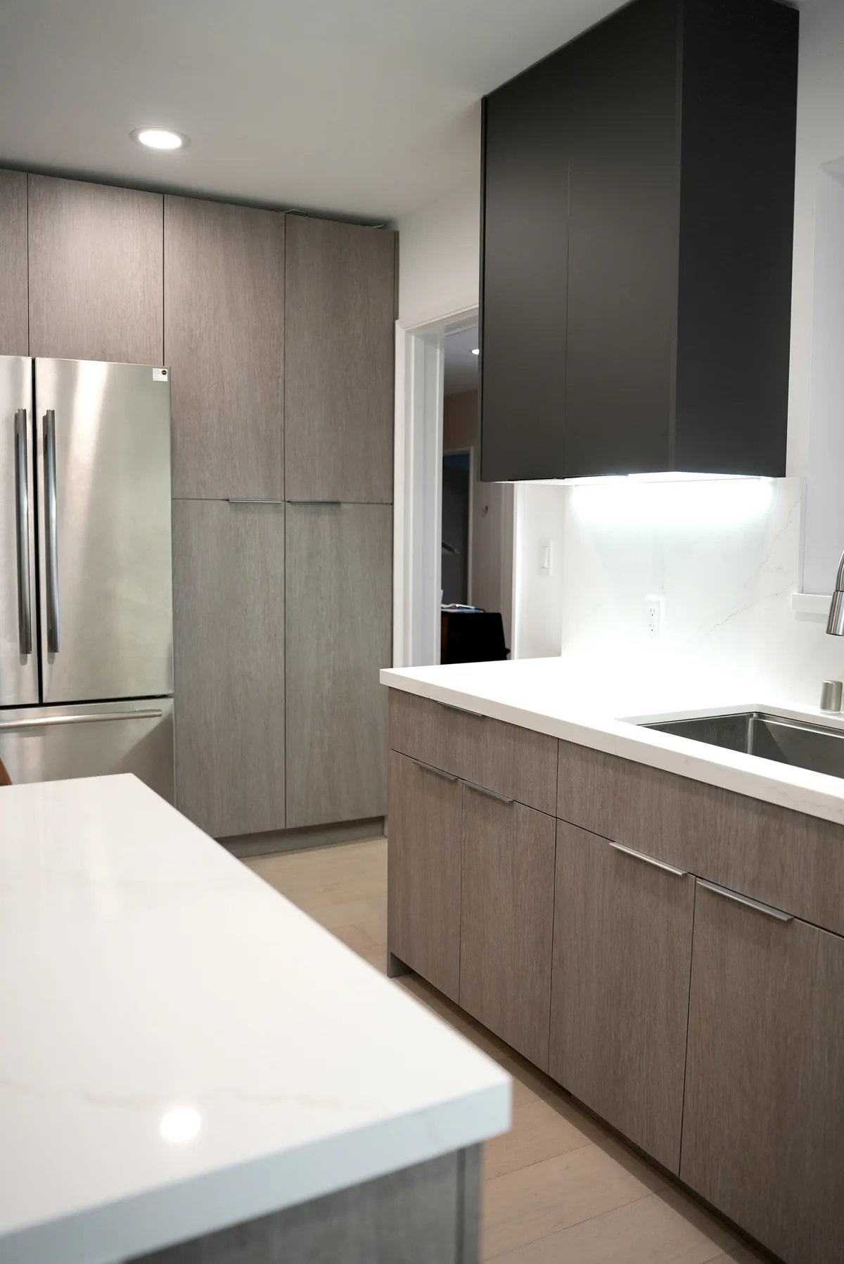 Wood-tone kitchen drawers and stainless steel refrigerator