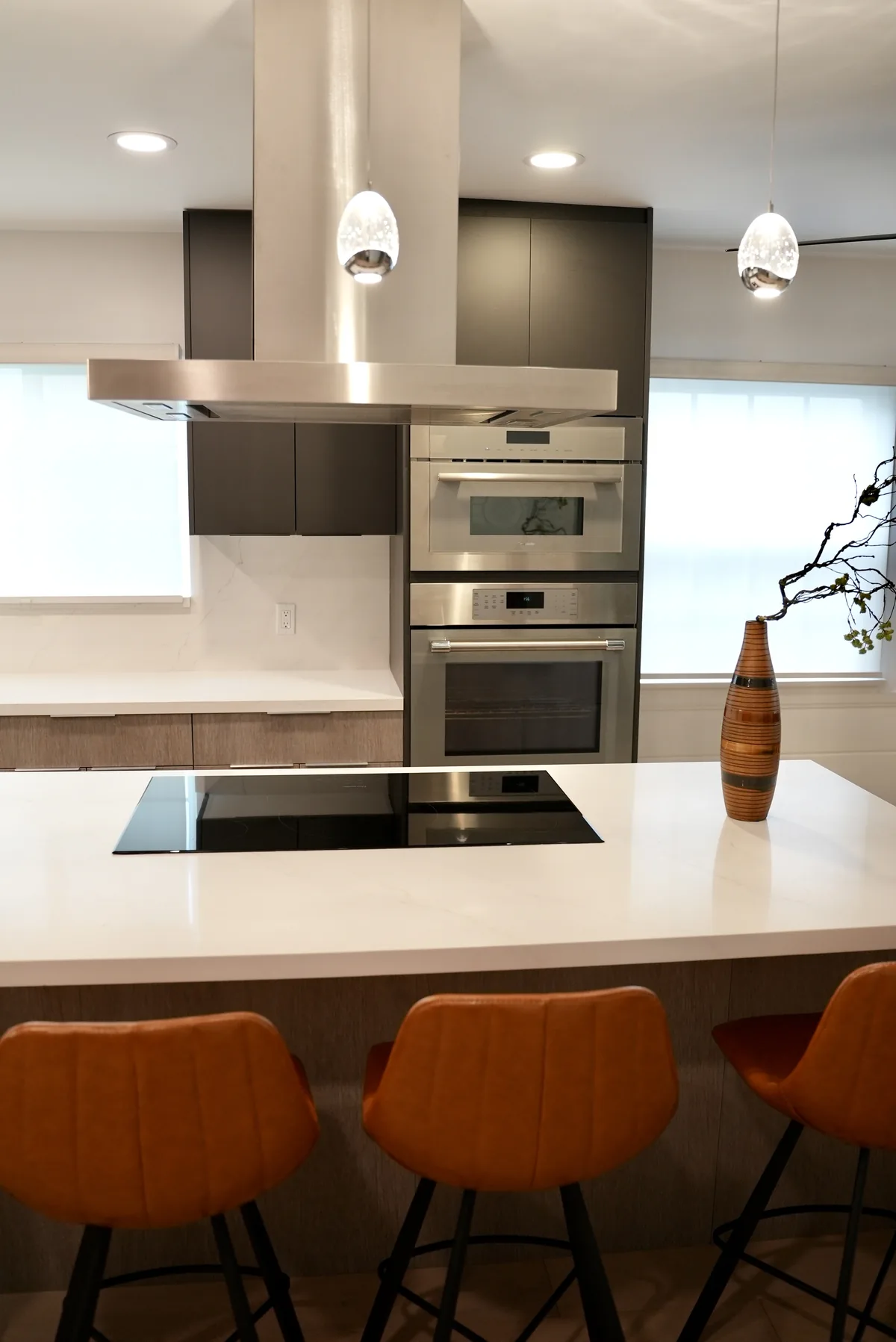 Brown bar stools tucked under the white kitchen island
