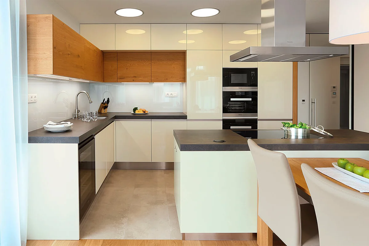 Two-tone European kitchen in Los Angeles with white and wood slab-front cabinets and concrete-finish countertops